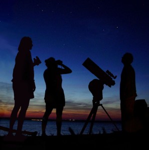 Three people enjoy the summer sky over the Delaware river, NJ, USA during the Perseid meteor shower in August, 2006.