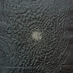 Beads represent a cluster of stars stitched onto a black background.