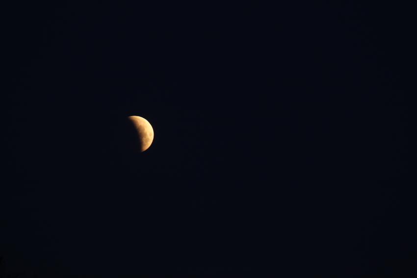 The Earth's shadow moved across the Moon as the lunar eclipse continued.