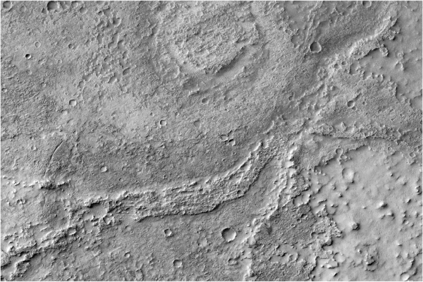 A moderately eroded fluvial sinuous ridge (FSR), with lots of small craters in it, that stands out clearly above the surrounding material. 