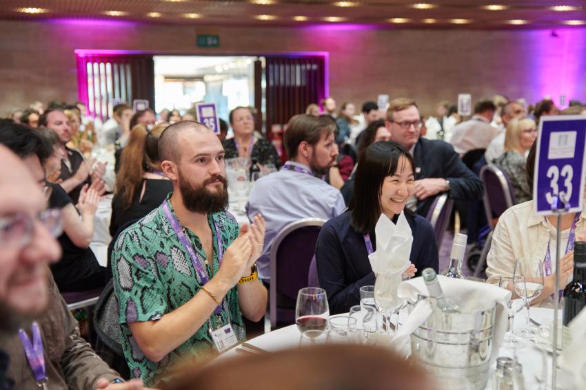 Attendees at the NAM 2025 conference dinner and RAS Awards ceremony applaud the winners.