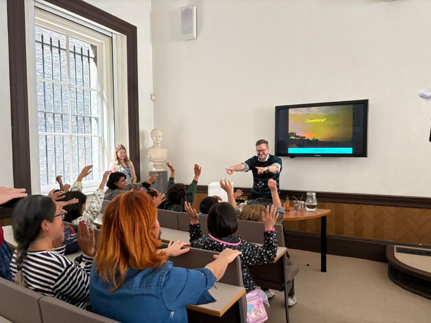 RAS Public Engagement Officer Adam Boal runs an activity in the lecture theatre.