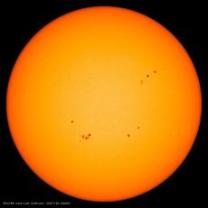 Image from the Solar Dynamics Observatory mission of the solar disk with multiple sunspots, which appear dark compared with their surroundings. Credit: HMI/SDO/NASA