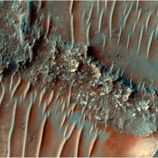 Colour image of a flat top, heavily eroded FSR. Sand dunes can be seen migrating over the top of the FSR. 